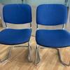 Pair of Blue Stacking Chairs (Small hole in 1 chair)